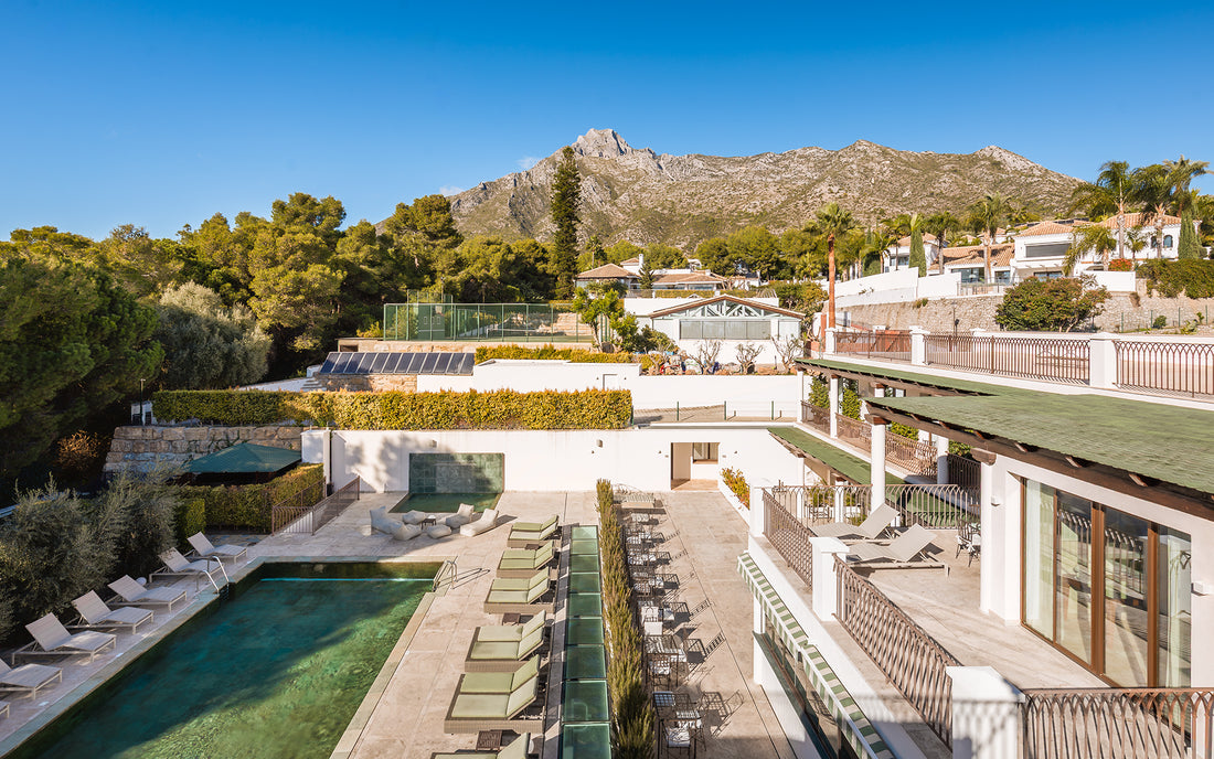 Aerial view of the Oasis Premium Recovery residence, its pool and the Sierra Blanca mountains in Marbella